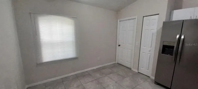 a view of an empty room and a window