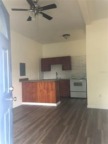 a view of a room with a wooden floor and entryway
