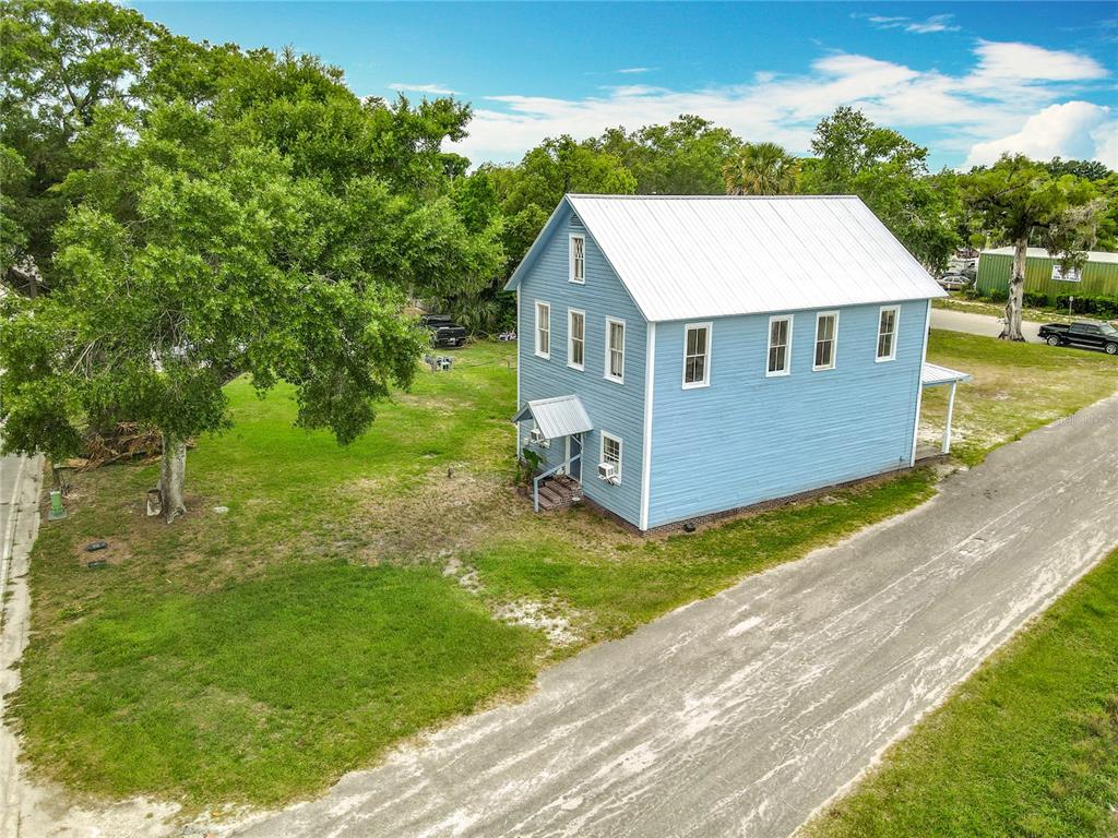 161 West 2nd Avenue Pierson, FL 32180 - Photo 18 of 32 a aerial view of a house in a big yard with large trees