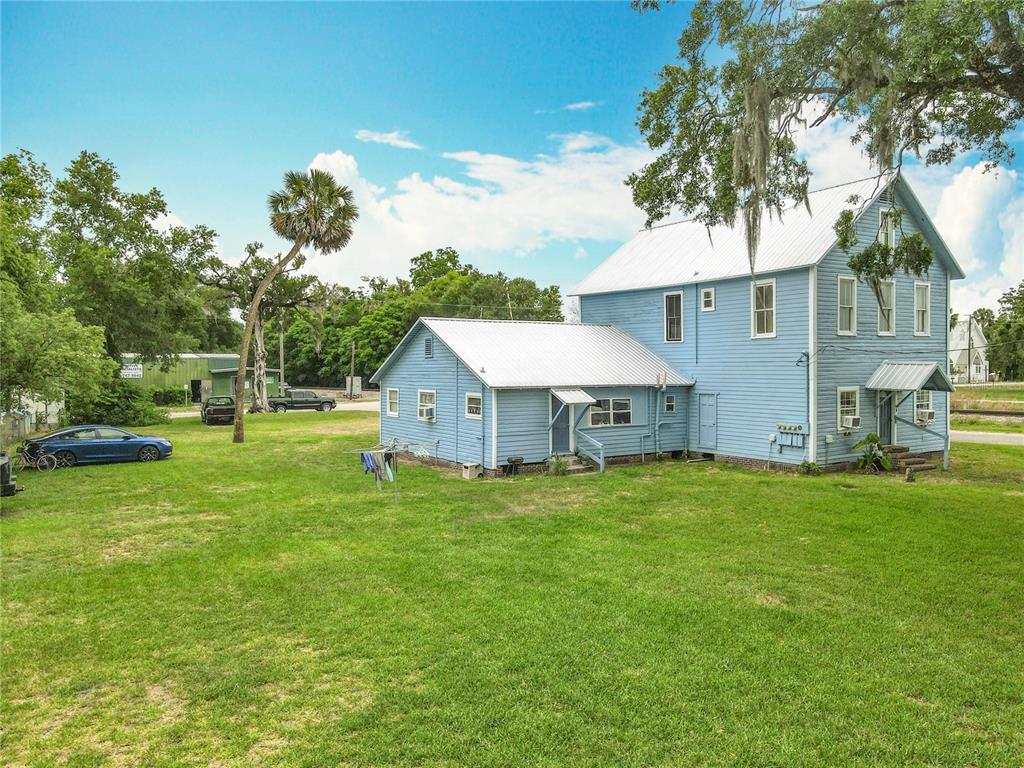 161 West 2nd Avenue Pierson, FL 32180 - Photo 20 of 31 a front view of a house with a yard and trees