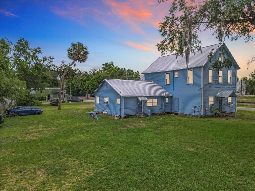 161 West 2nd Avenue Pierson, FL 32180 - Photo 2 of 32 a view of a yard in front of a house with large trees