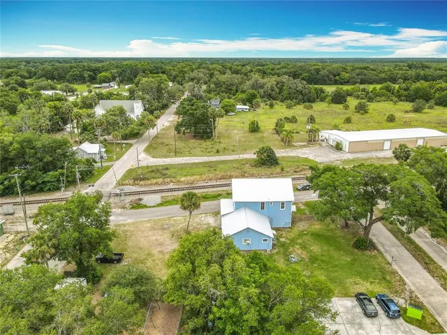 an aerial view of residential houses with outdoor space