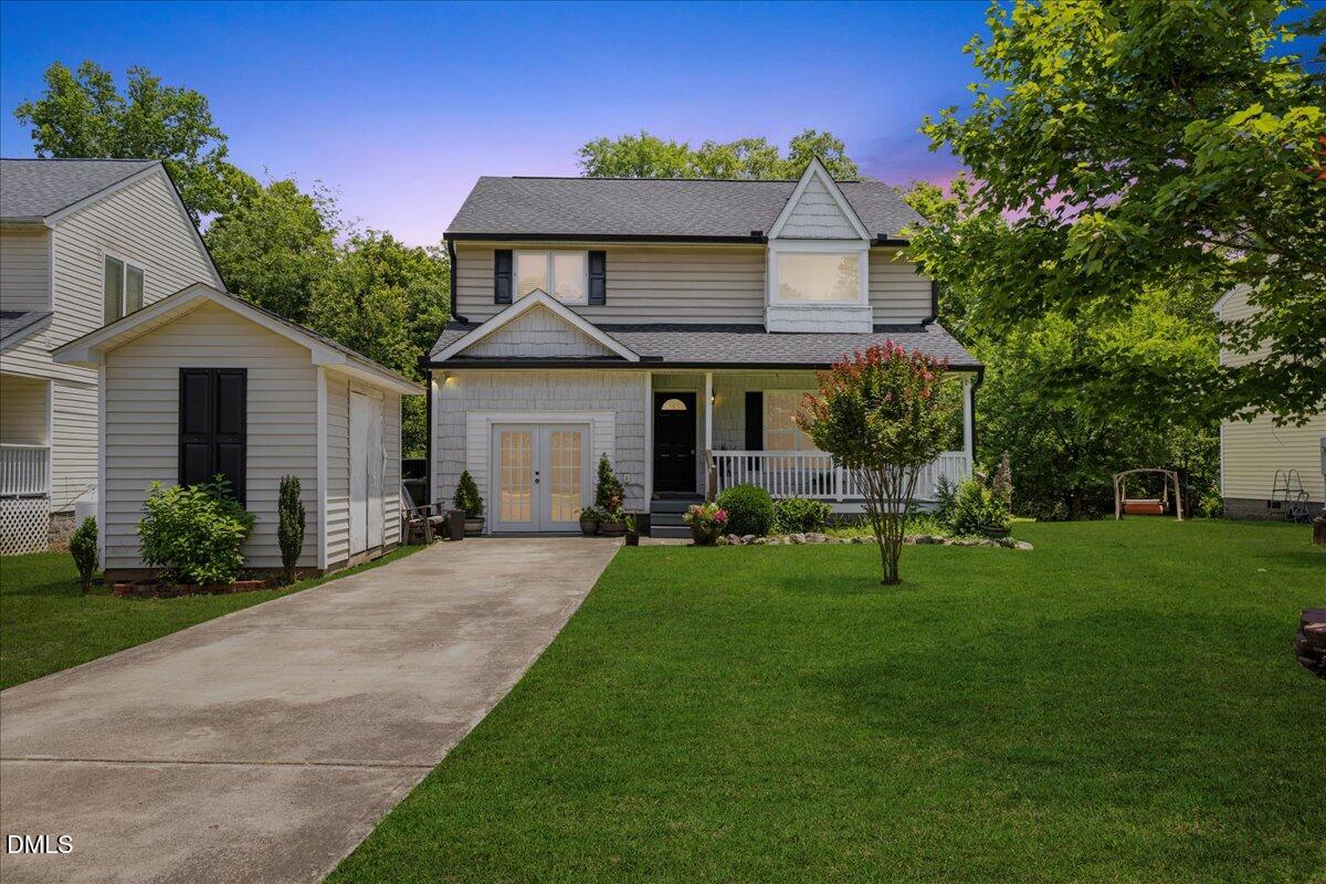 a front view of a house with a garden and porch