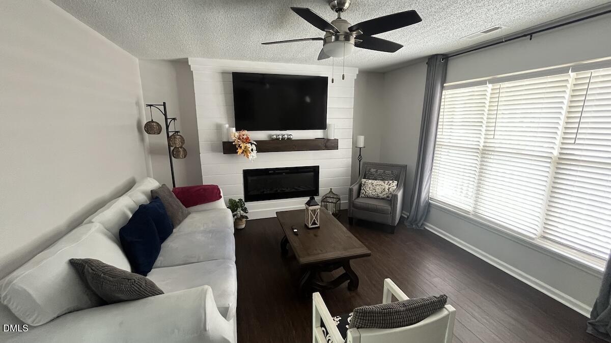 4708 River Boat Landing Court Raleigh, NC 27604 - Photo 10 of 61 a living room with furniture and a flat screen tv