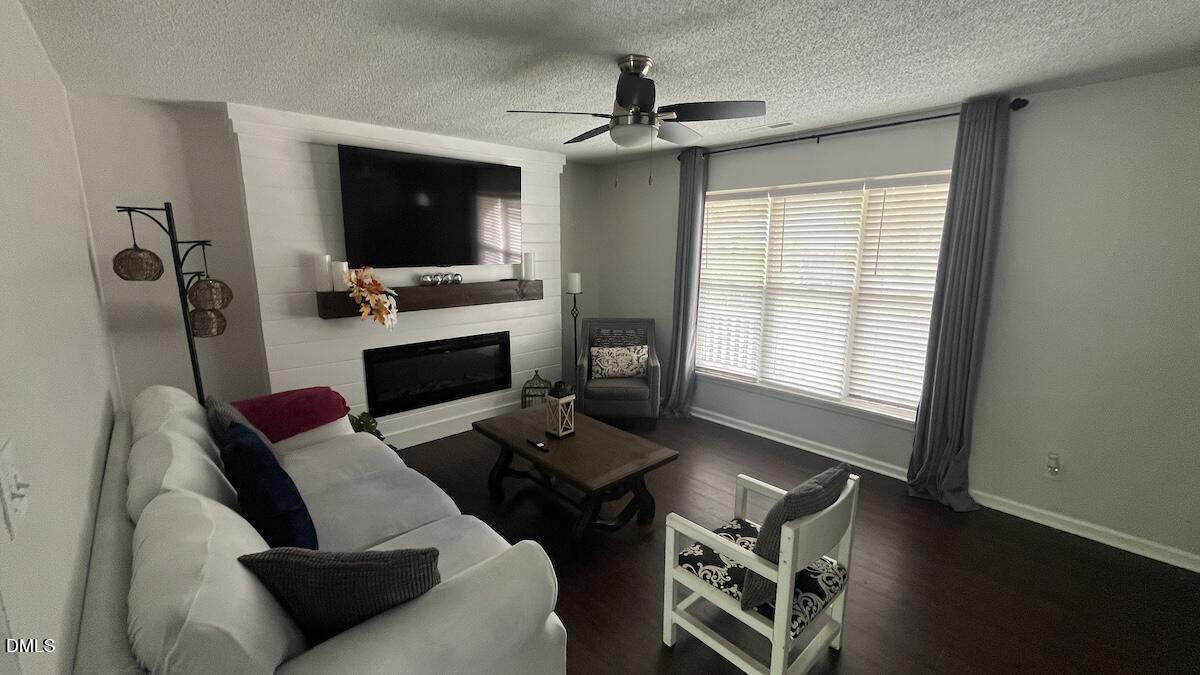 4708 River Boat Landing Court Raleigh, NC 27604 - Photo 12 of 61 a living room with furniture fireplace and flat screen tv
