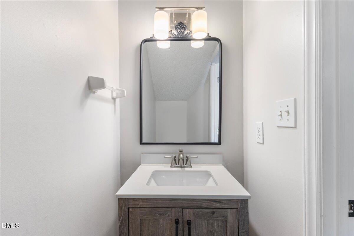 4708 River Boat Landing Court Raleigh, NC 27604 - Photo 13 of 61 a bathroom with a sink and a mirror