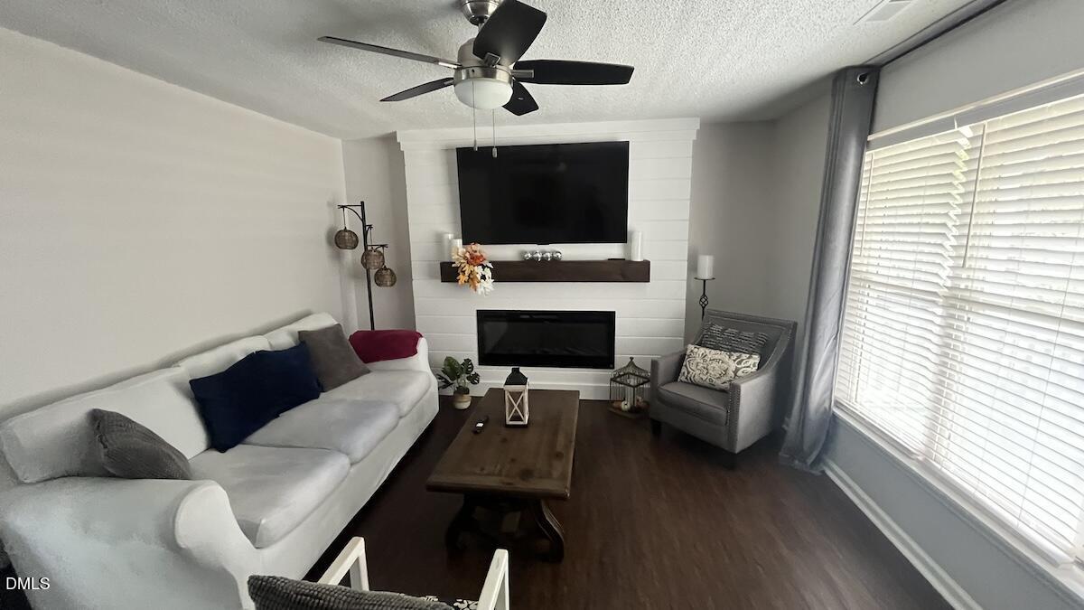 4708 River Boat Landing Court Raleigh, NC 27604 - Photo 14 of 61 a living room with furniture a flat screen tv and a fireplace