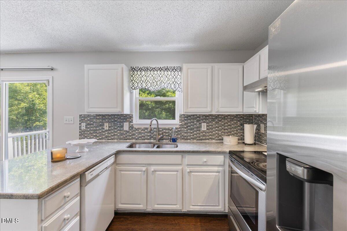 4708 River Boat Landing Court Raleigh, NC 27604 - Photo 21 of 61 a kitchen with a sink stove and cabinets