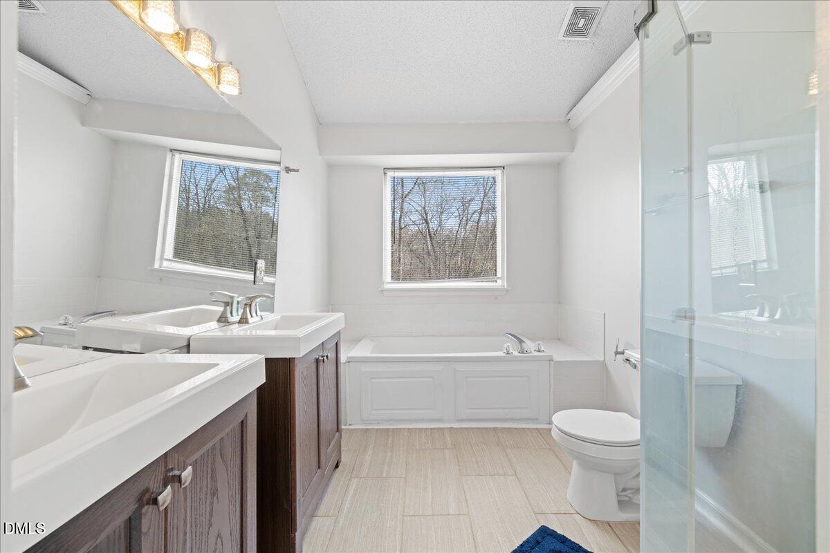 4708 River Boat Landing Court Raleigh, NC 27604 - Photo 29 of 61 a bathroom with a sink a toilet and shower