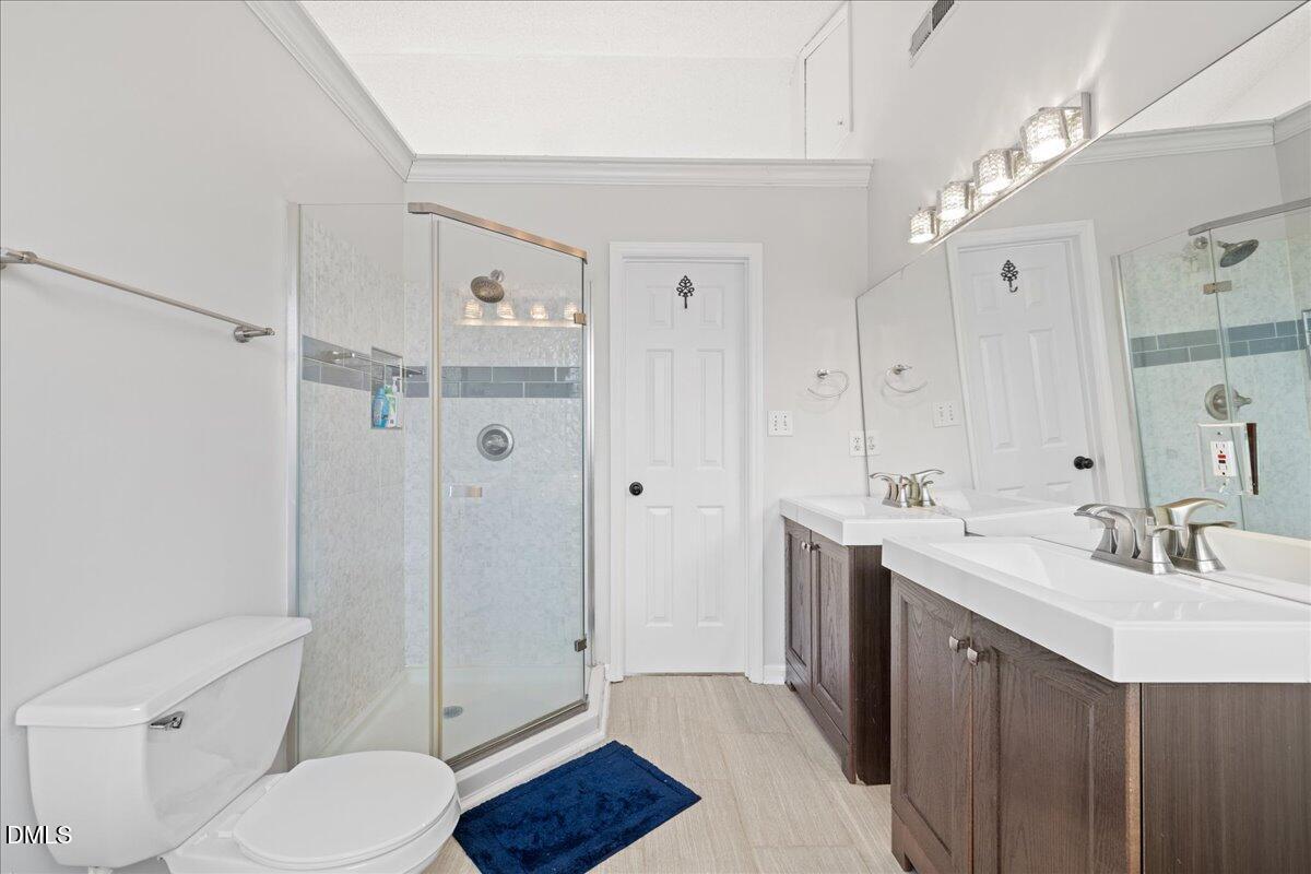 4708 River Boat Landing Court Raleigh, NC 27604 - Photo 31 of 61 a bathroom with a sink a toilet and shower