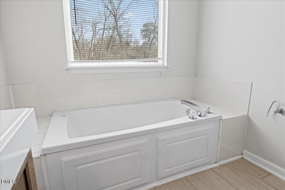 4708 River Boat Landing Court Raleigh, NC 27604 - Photo 32 of 61 a view of a bathroom with bathtub