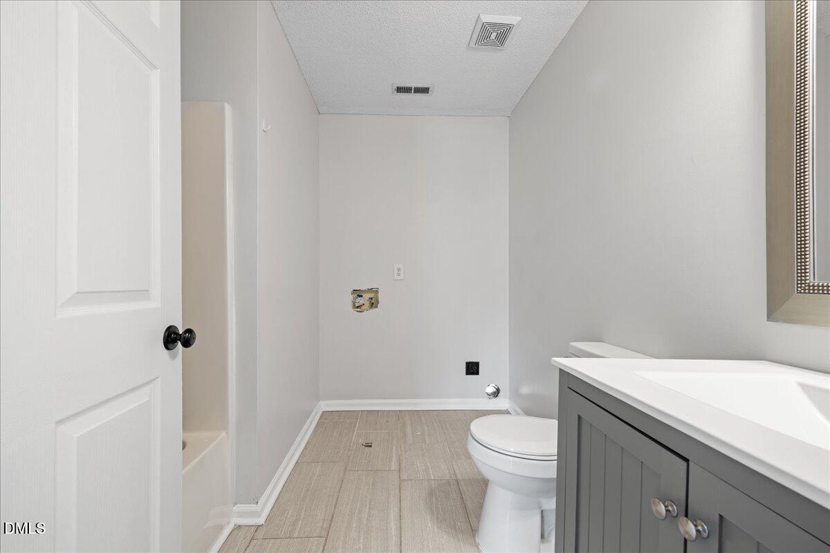 4708 River Boat Landing Court Raleigh, NC 27604 - Photo 35 of 61 a bathroom with a sink a toilet and shower