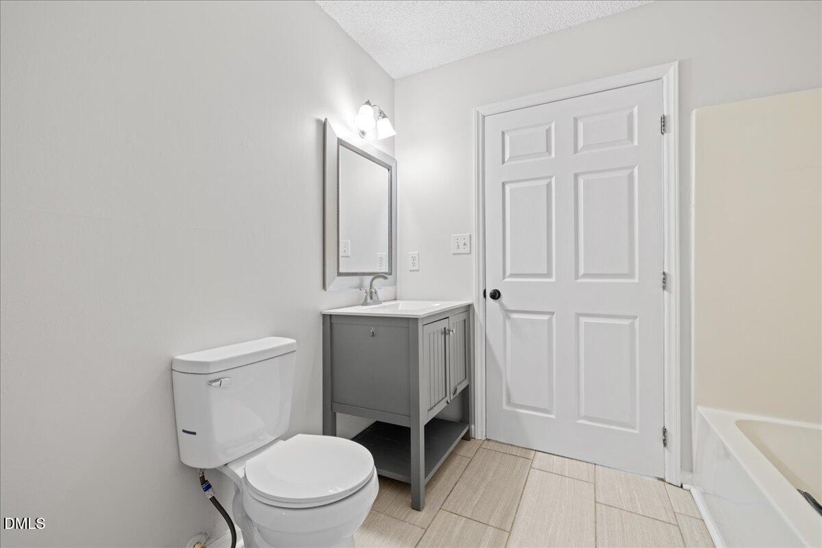 4708 River Boat Landing Court Raleigh, NC 27604 - Photo 36 of 61 a bathroom with a toilet a sink and mirror