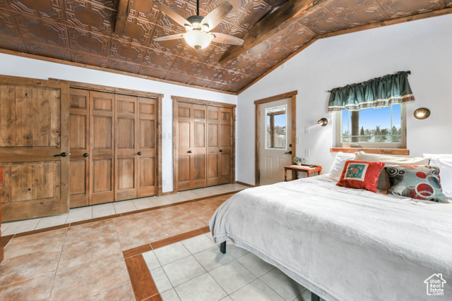 2029 West Tollgate Road Coalville, UT 84017 - Photo 30 of 43 Bedroom featuring light tile patterned floors, multiple closets, ceiling fan, vaulted ceiling, and an ornate ceiling