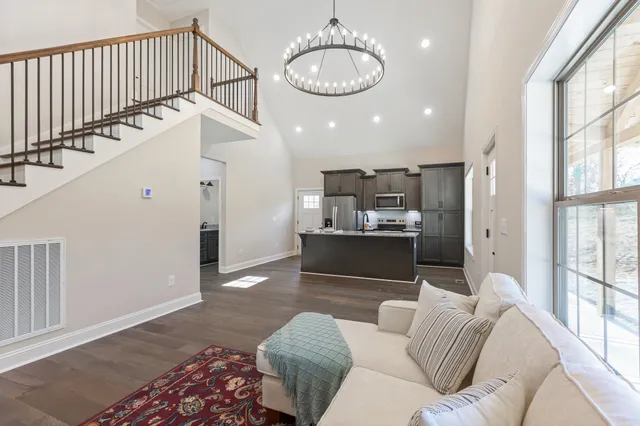 a living room with kitchen island furniture and a wooden floor