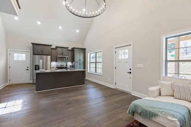 a living room with furniture and a wooden floor