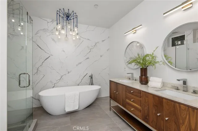 a white tub sitting next to a white sink