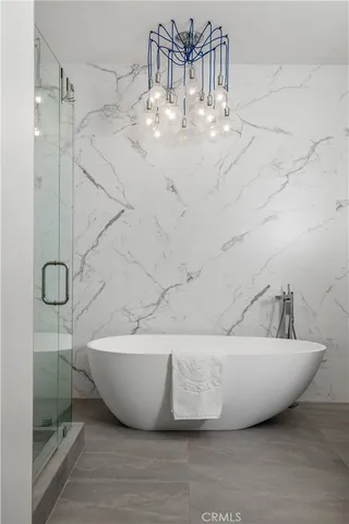 a bedroom with a bed a mirror and a window