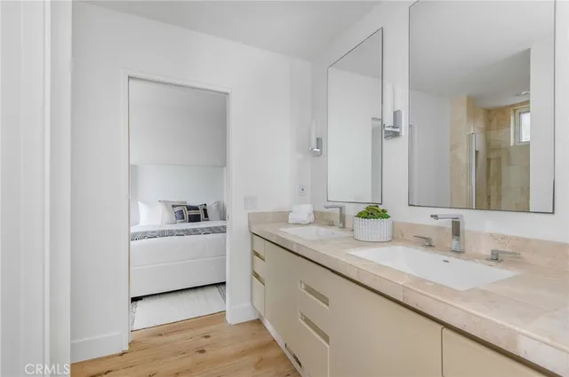 a bedroom with a bed and wooden floor