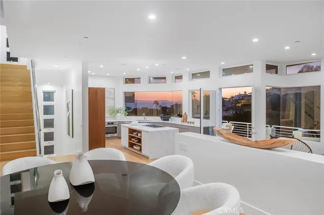 a kitchen with a table chairs sink and refrigerator