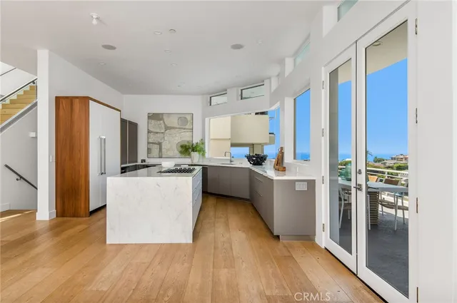 a kitchen with a refrigerator a sink and cabinets