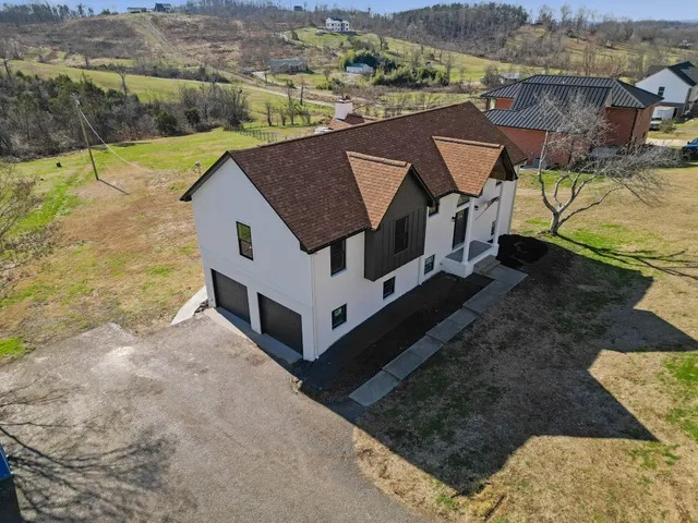 a view of a house with backyard and lake view