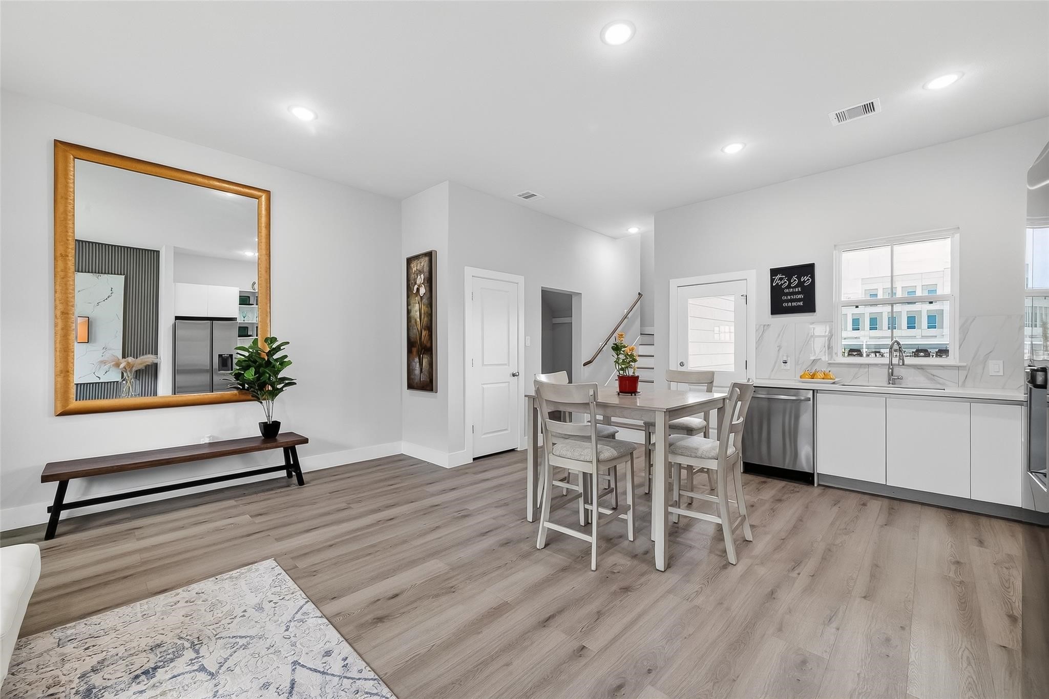 6702 Metro Boulevard, Unit 2 Houston, TX 77083 - Photo 11 of 39 a living room with furniture a wooden floor and a sink