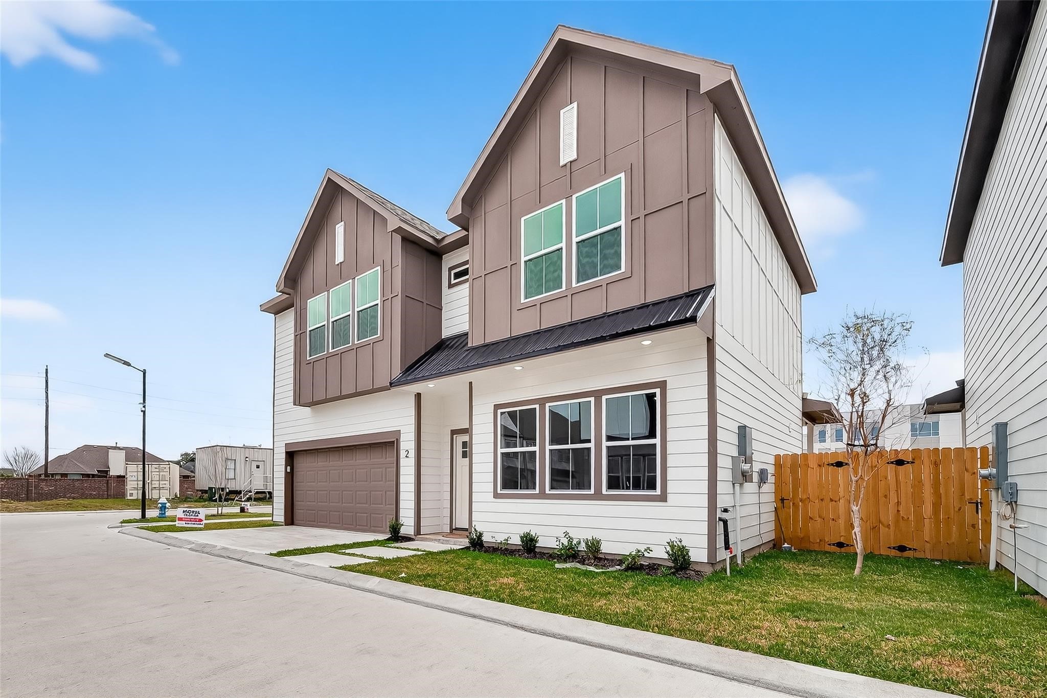 6702 Metro Boulevard, Unit 2 Houston, TX 77083 - Photo 2 of 39 a front view of a house with a yard and garage