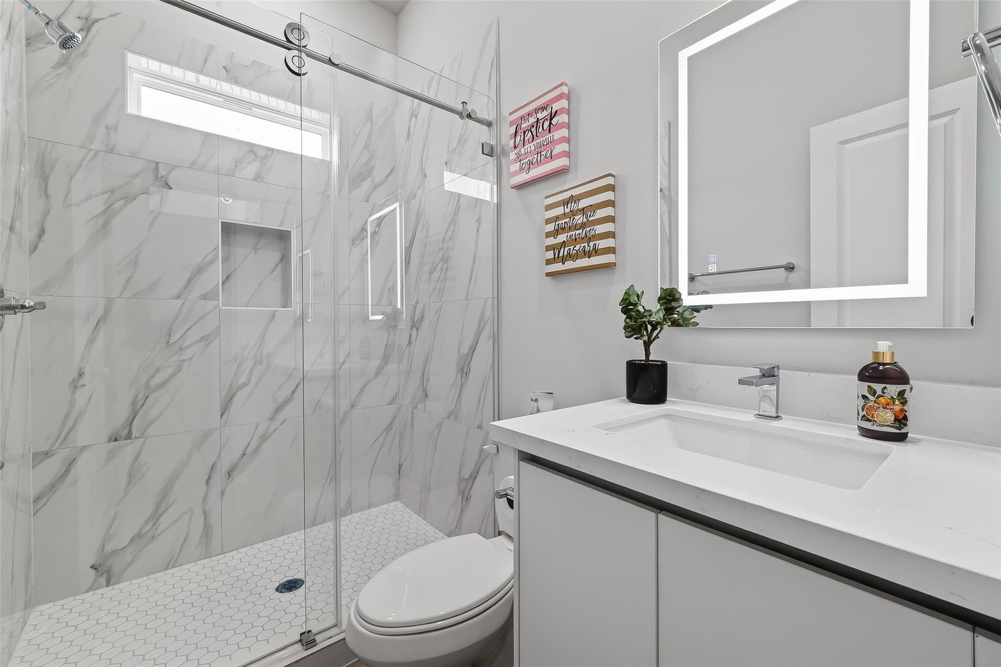 6702 Metro Boulevard, Unit 2 Houston, TX 77083 - Photo 21 of 39 a bathroom with a sink a toilet and shower