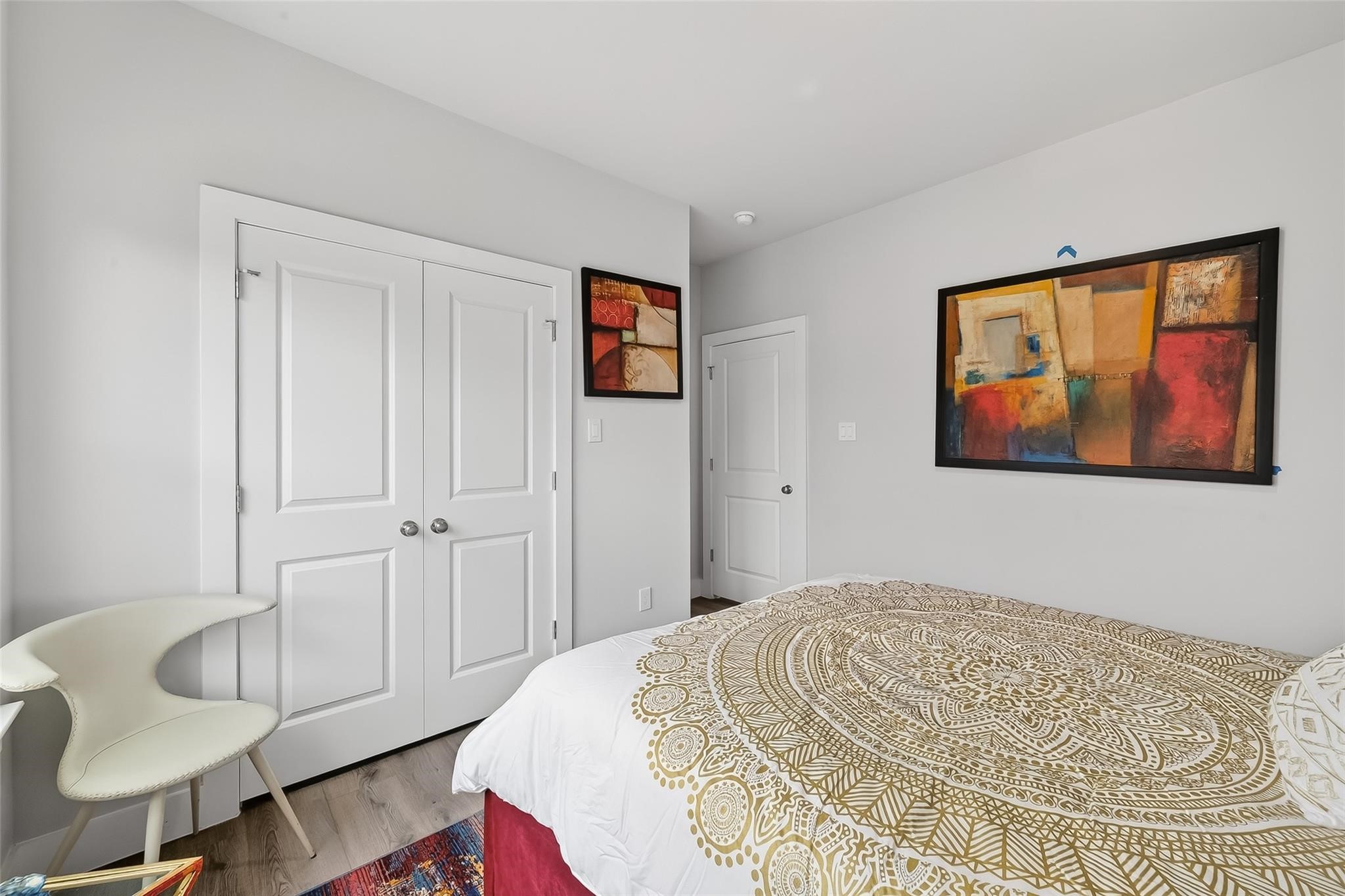 6702 Metro Boulevard, Unit 2 Houston, TX 77083 - Photo 28 of 39 a bedroom with a bed and wooden floor