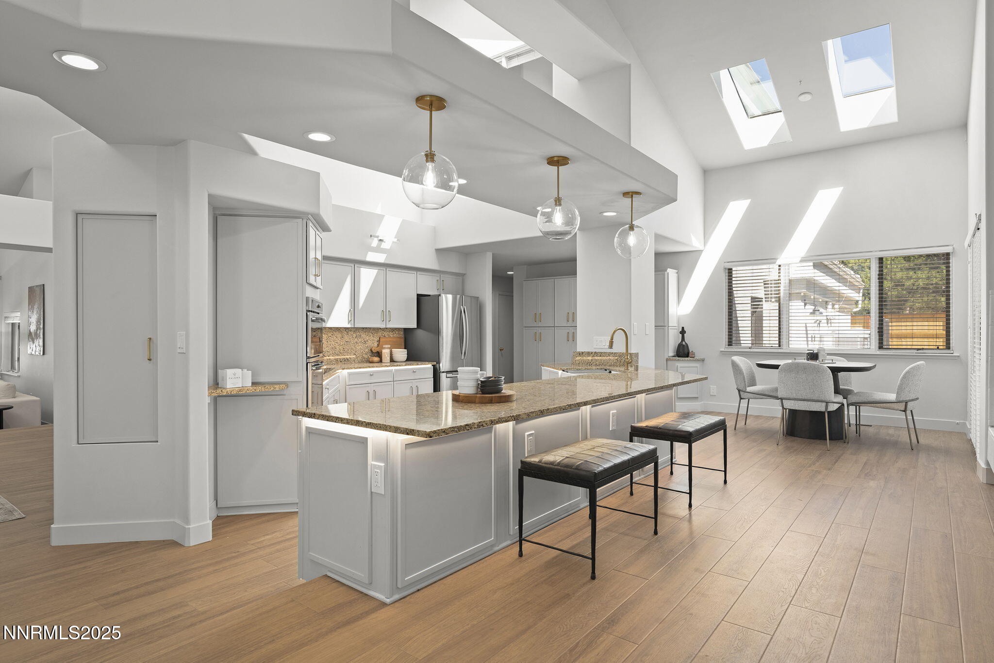 4292 Caughlin Parkway Reno, NV 89519 - Photo 11 of 37 a kitchen with stainless steel appliances kitchen island hardwood floor and a refrigerator