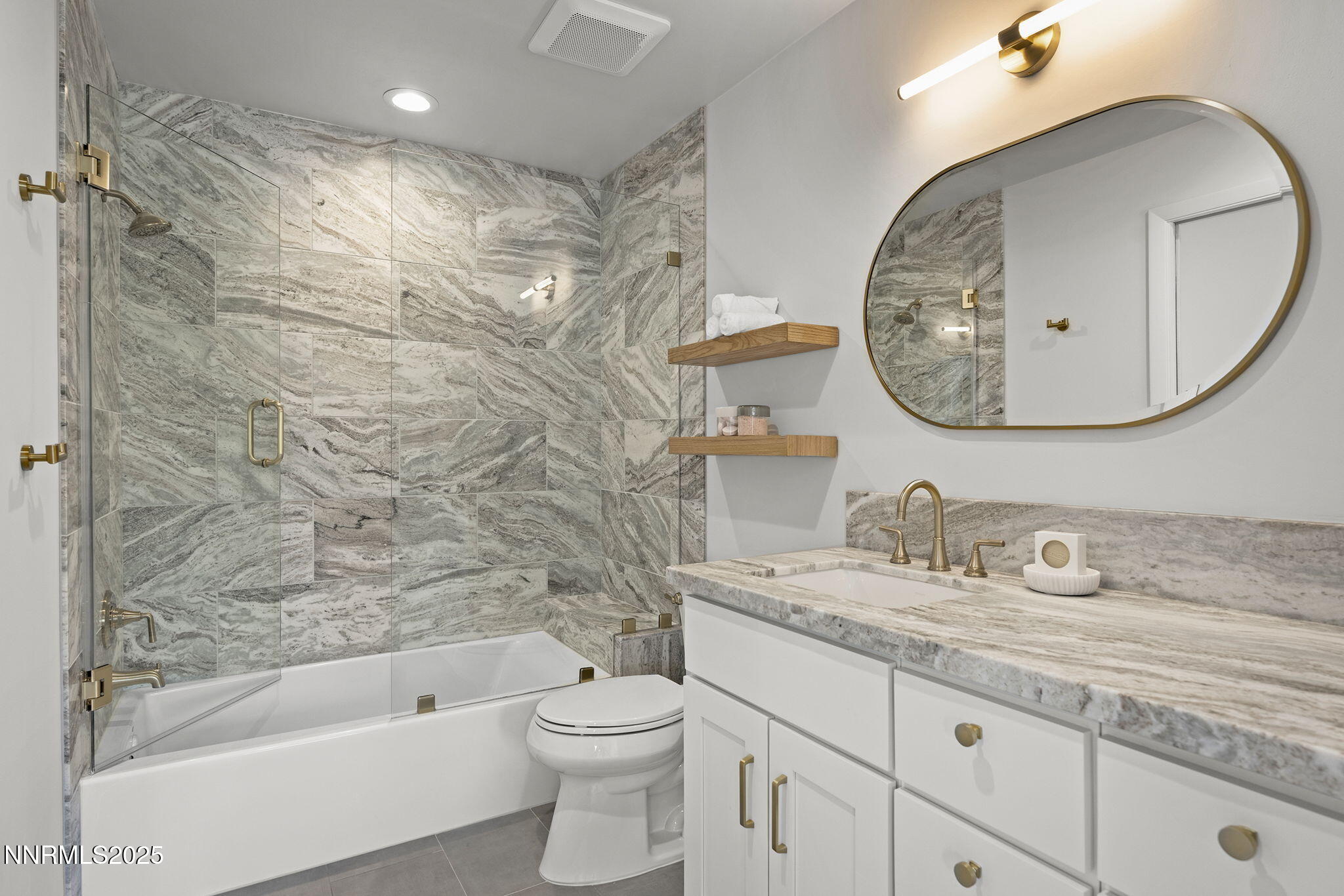 4292 Caughlin Parkway Reno, NV 89519 - Photo 29 of 37 a bathroom with a granite countertop sink a toilet and a mirror