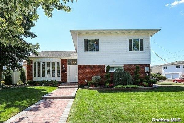 668 Jackie Lane Baldwin, NY 11510 - Photo 1 of 1 a front view of a house with garden