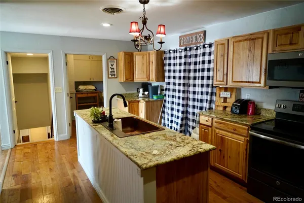 a kitchen with a refrigerator and a sink