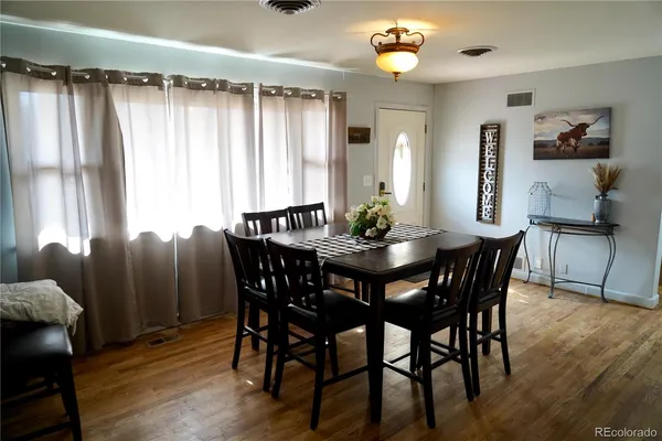 a view of a dining room with furniture and window
