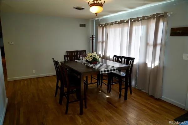 a view of a dining room with furniture and wooden floor