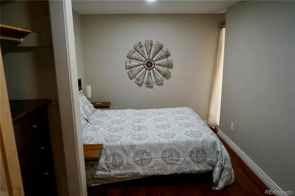 a bedroom with a bed and a large mirror