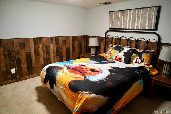 a living room with furniture a flat screen tv and a floor to ceiling window