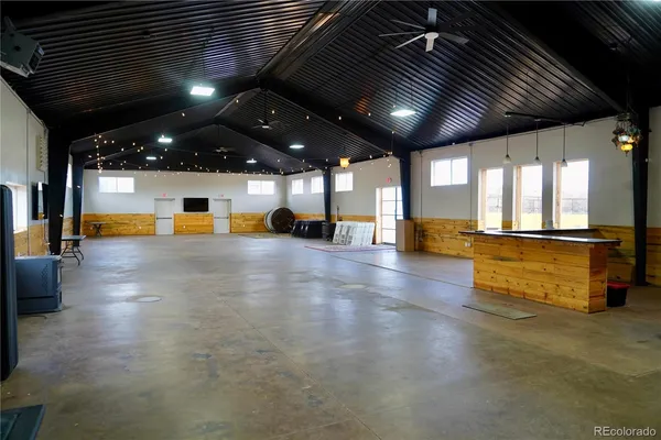 a bathroom with a granite countertop sink a toilet and a mirror