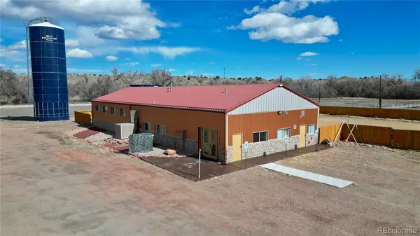 a view of a house with a patio and a tree