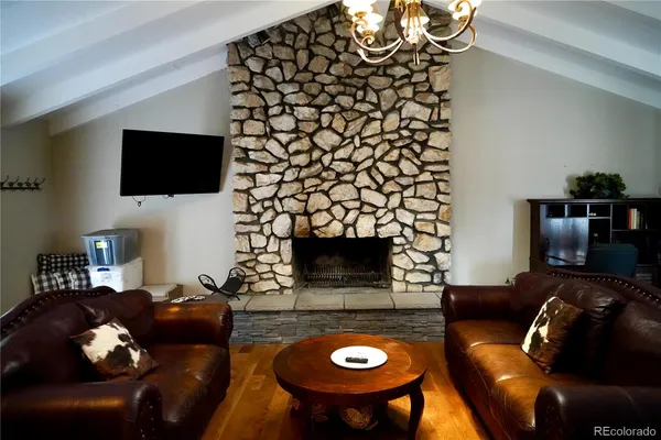 a living room with furniture and a chandelier