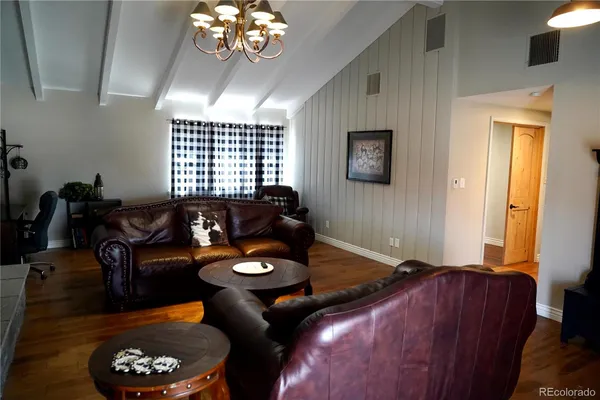 a dining room with furniture and wooden floor