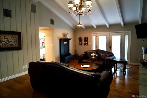 a kitchen with a refrigerator a stove top oven a dining table and chairs