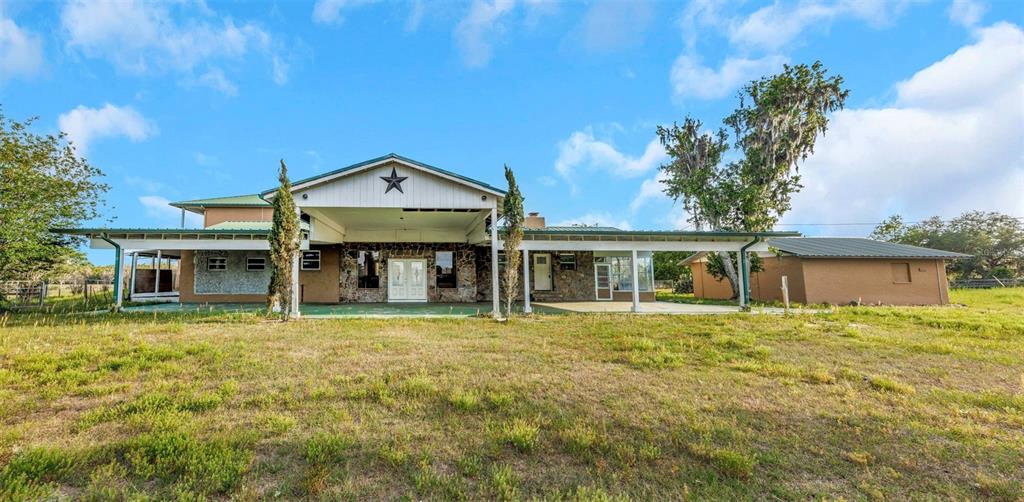 20138 Bowman Road Spring Hill, FL 34610 - Photo 6 of 40 a front view of a house with a garden