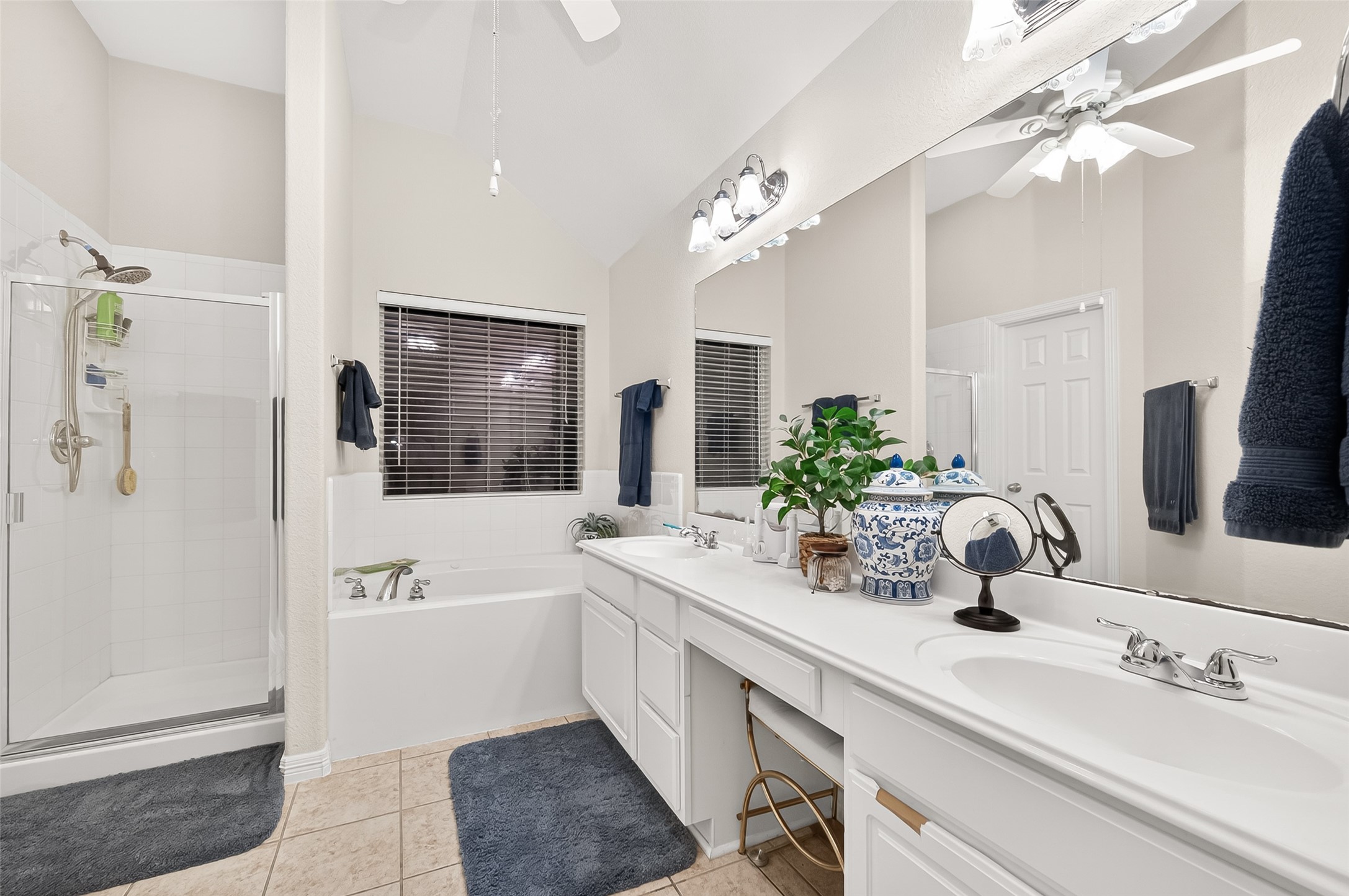 12455 West Summerlin Conroe, TX 77302 - Photo 20 of 31 a bathroom with a double vanity sink a mirror a bathtub and shower