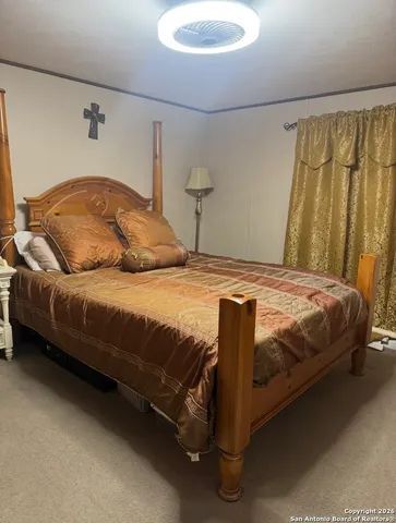 a bedroom with a bed and a chair
