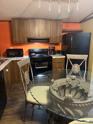 a kitchen with a table chairs and a stove