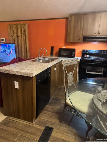 a kitchen with a sink cabinets and appliances