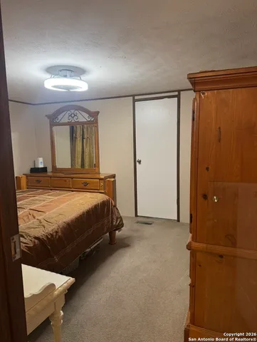 a bedroom with a bed and a mirror