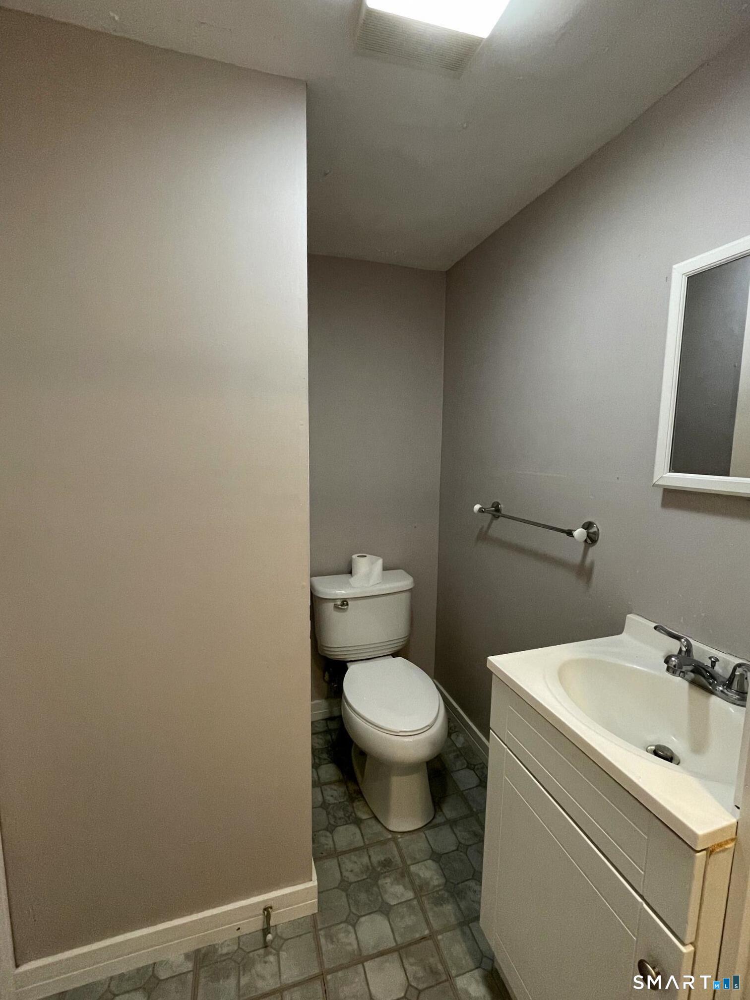 18 Old South Cove Road Old Saybrook, CT 06475 - Photo 33 of 40 a bathroom with a sink toilet and a mirror